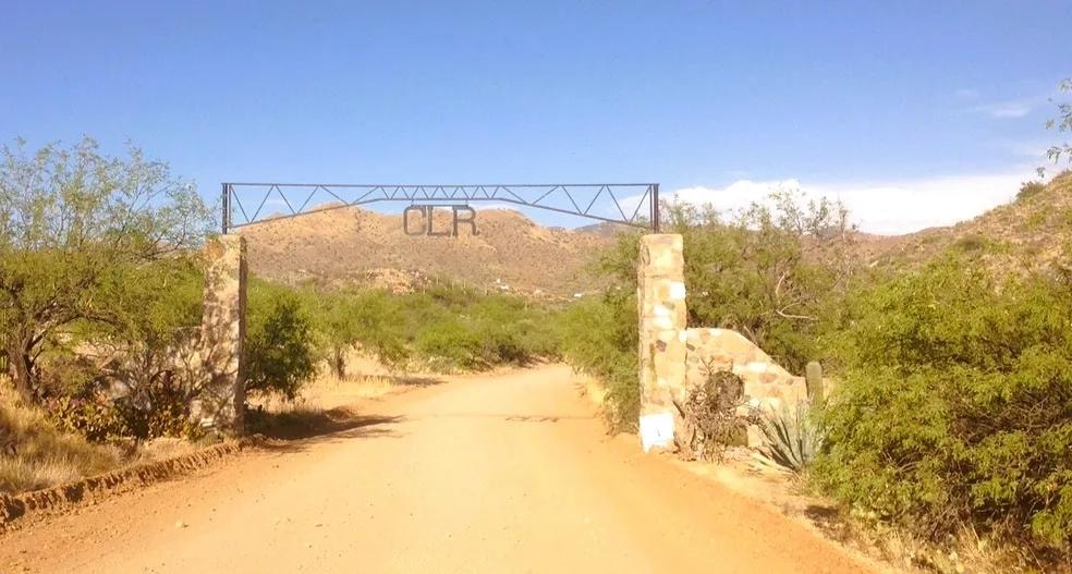 CLR ranch entrance gate with stone pillars